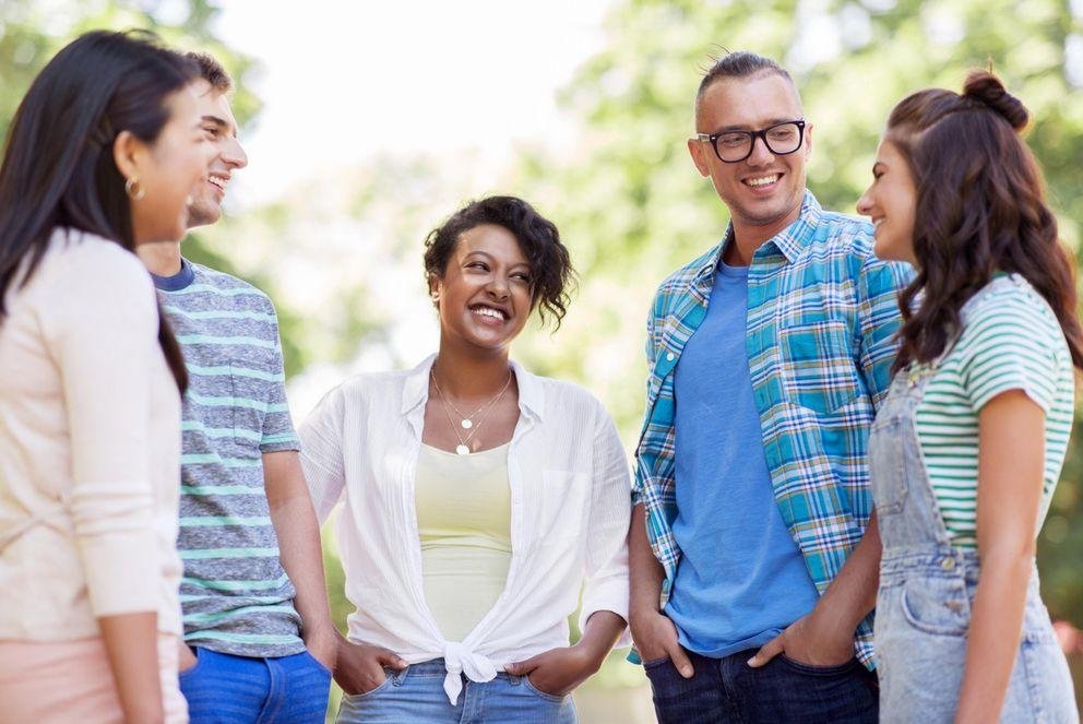 group of happy international friends in park
